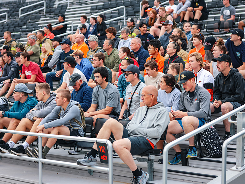 A group of people sits in the stands waiting to begin the eighth annual 9/11 Memorial Stair Climb at Boone Pickens Stadium.