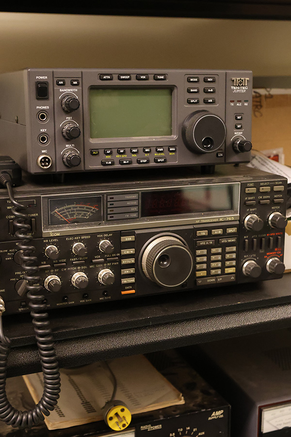 Radio equipment sits on a shelf in a lab-type setting.