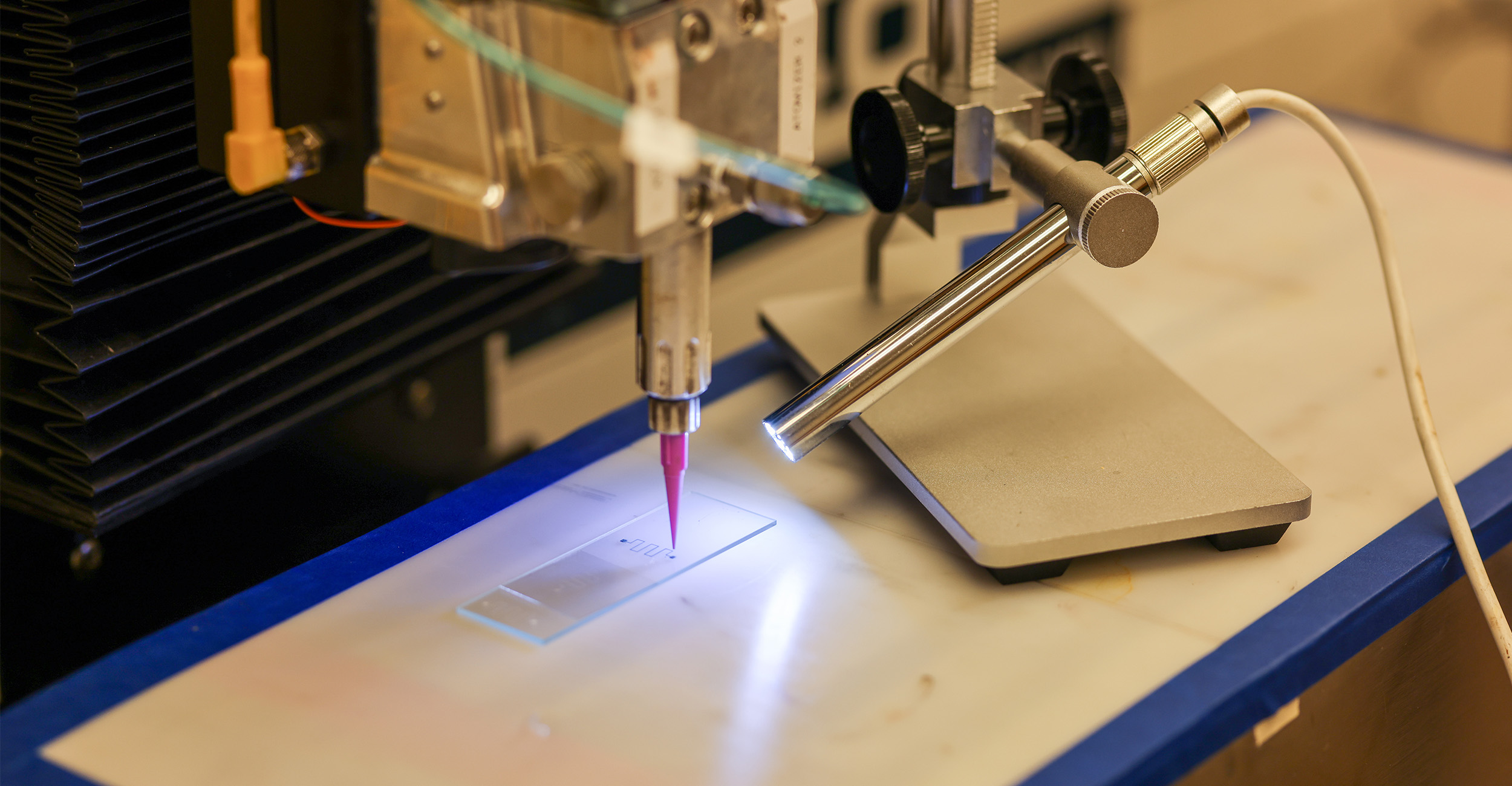 A 3D printer printing micro-scale functional devices using conductive ink.
