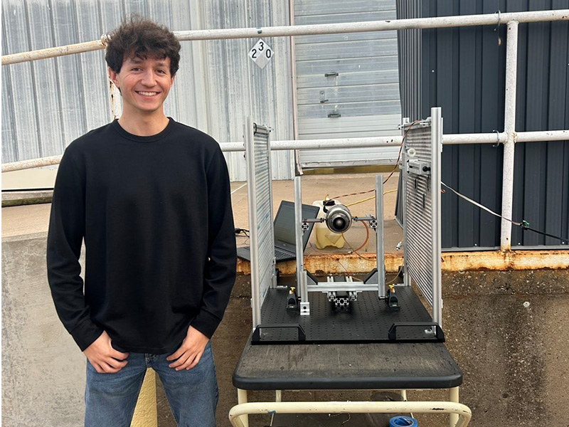 Brody Richardson stands with a project he has worked on as a member of P4.