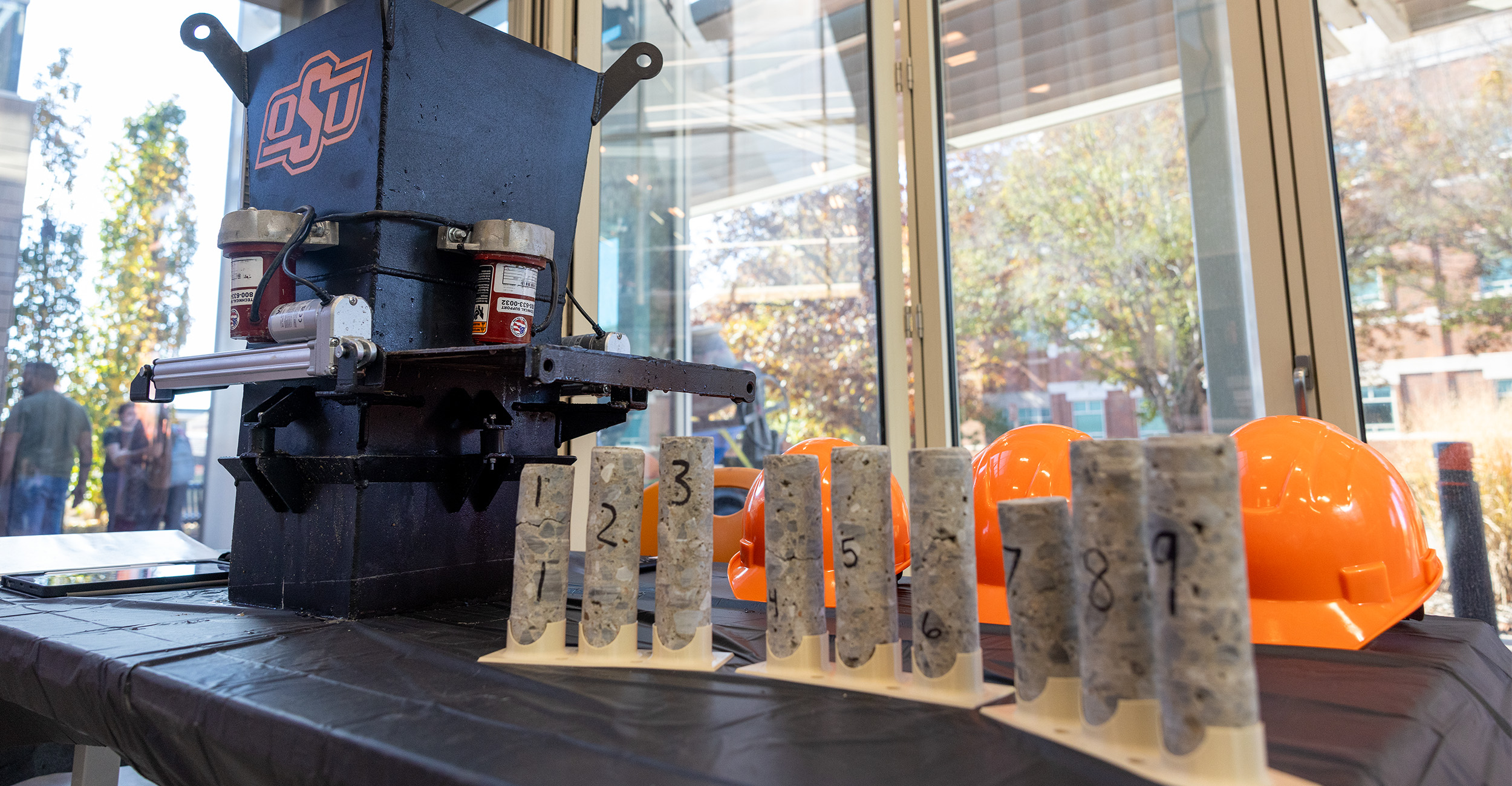 Concrete samples are shown on a table during the 2025 Senior Design Expo. The different samples are labeled with a number to denote that they are different samples. The team Concrete Cowboys demonstrated a process to 3D print a concrete column.