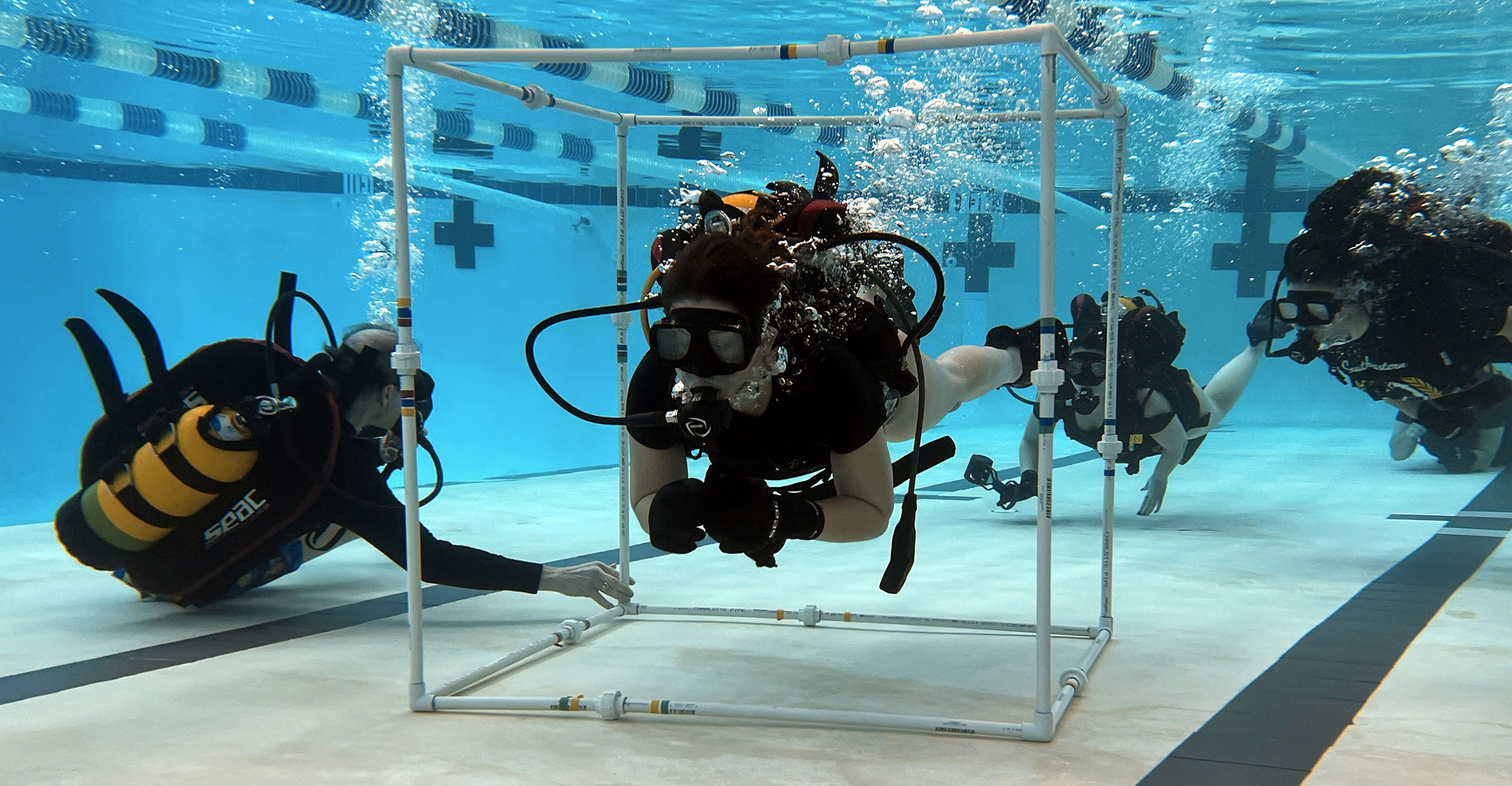 This photo provided by Texas Scuba Adventures shows participants in NASA's STELLAR program learning from NASA experts. Part of the activities one of the years involved underwater training to simulate zero gravity conditions.
