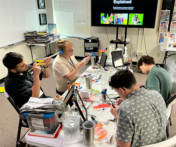 Participants in NASA's STELLAR program work on supplies for their classrooms during a program geared toward teachers learning from NASA personnel to implement those lessons into their classroom curriculum. 