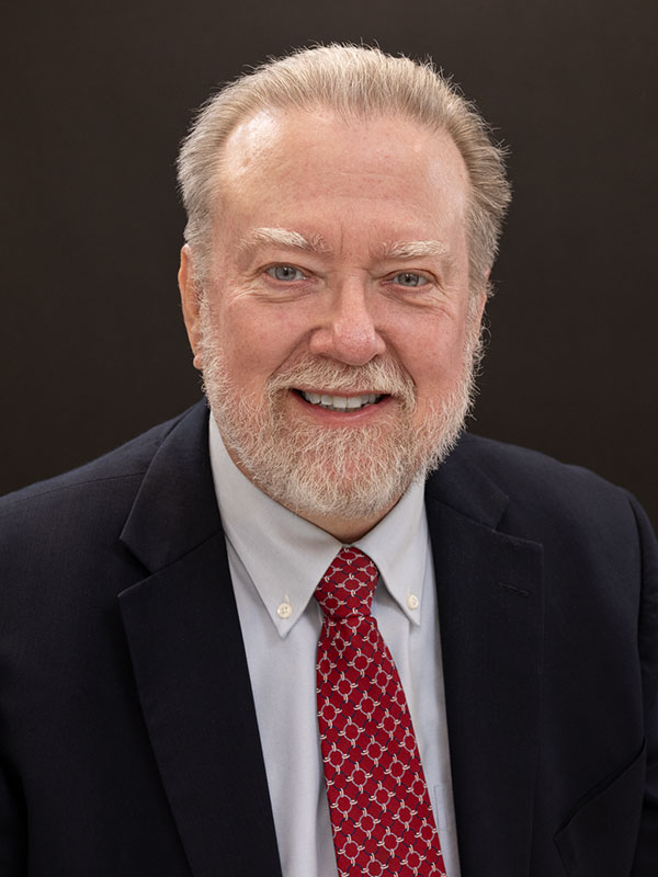 A man poses for a professional headshot.