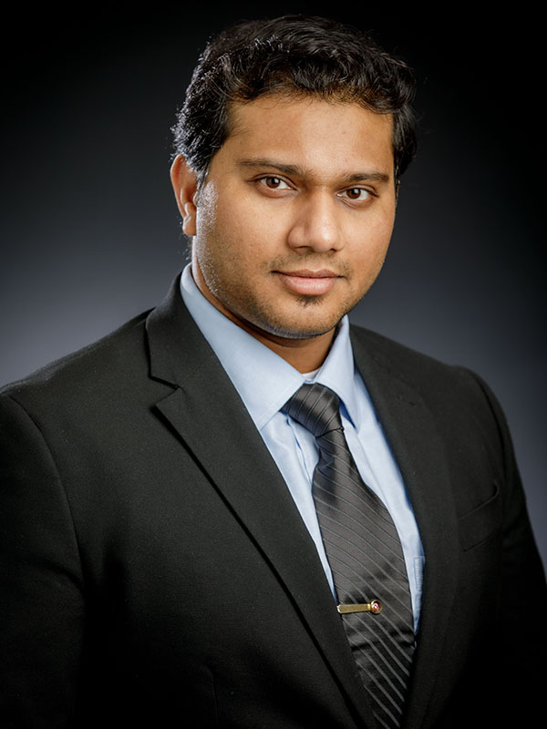 A man poses for a professional headshot.