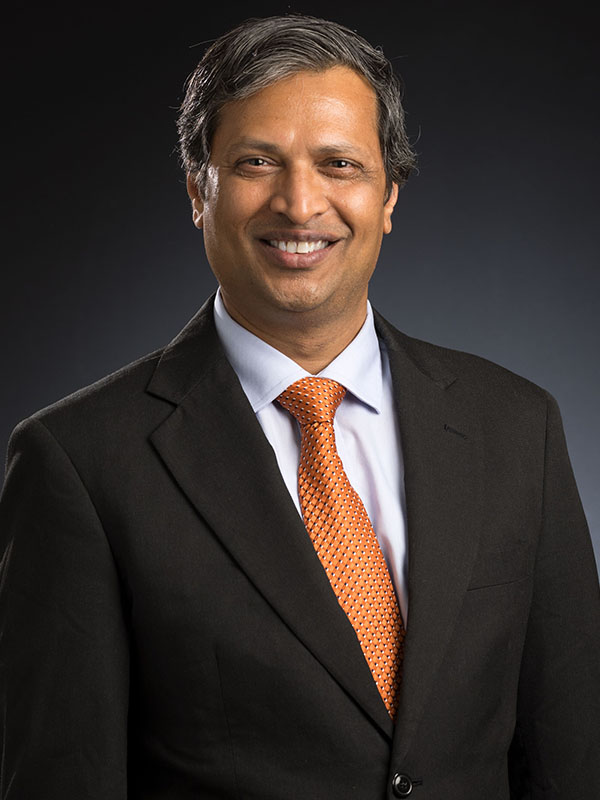 A man poses for a professional headshot.