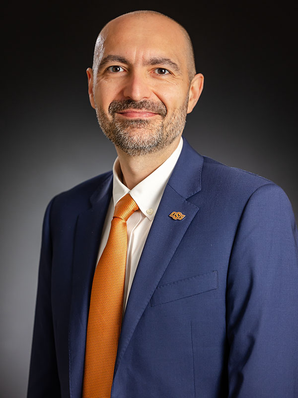 A man poses for a professional headshot.