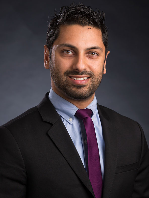 A man poses for a professional headshot.