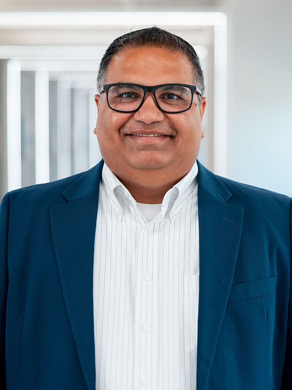 A man poses for a professional headshot.