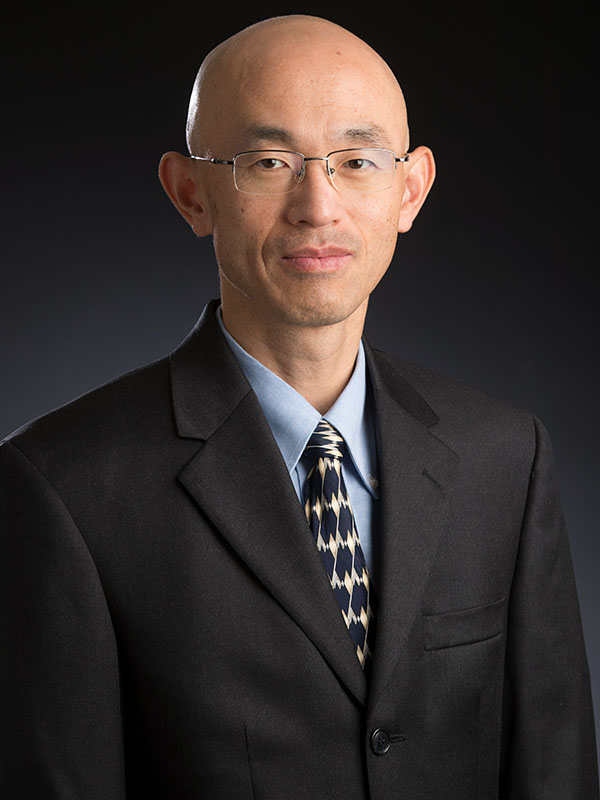 A man poses for a professional headshot.