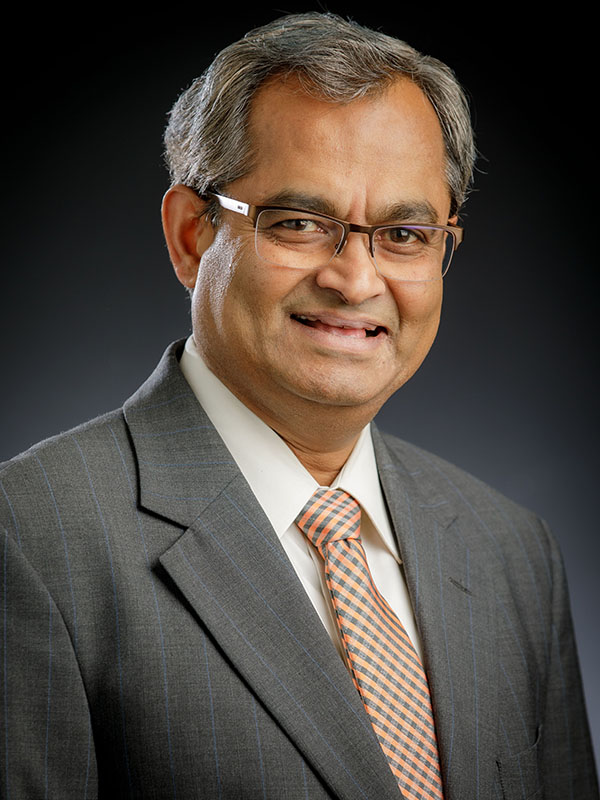 A man poses for a professional headshot.