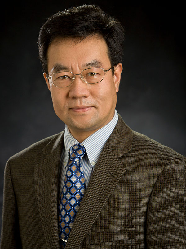 A man poses for a professional headshot.
