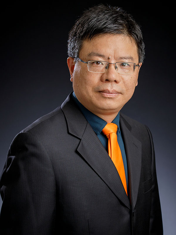 A man poses for a professional headshot.