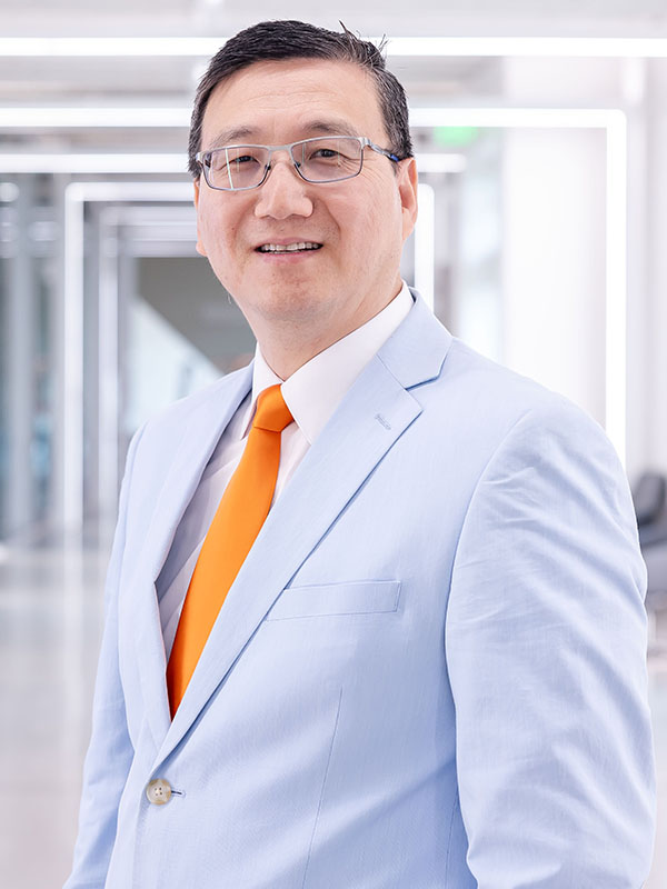 A man poses for a professional headshot.