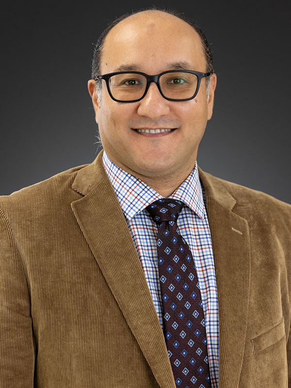 A man poses for a professional headshot.