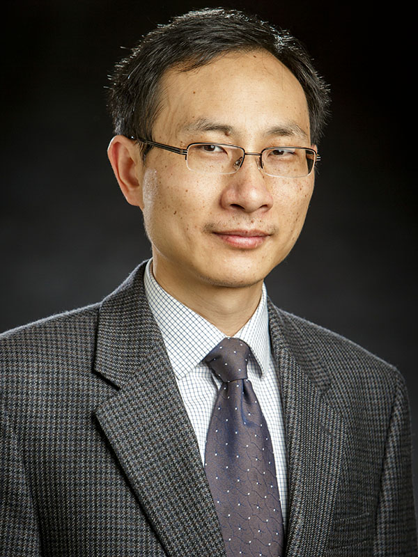 A man poses for a professional headshot.