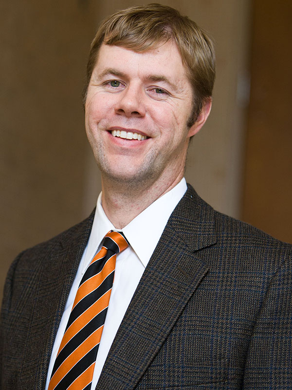 A man poses for a professional headshot.