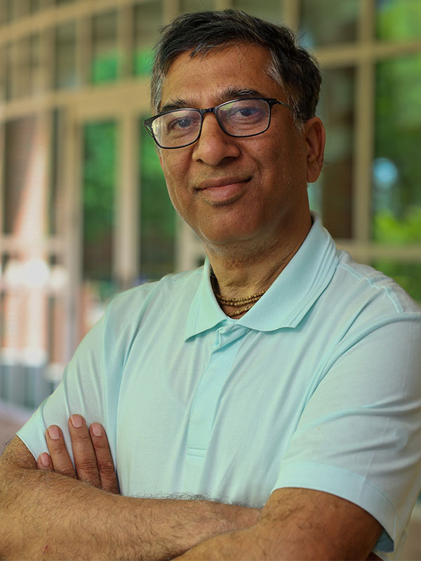 A man poses for a professional headshot.