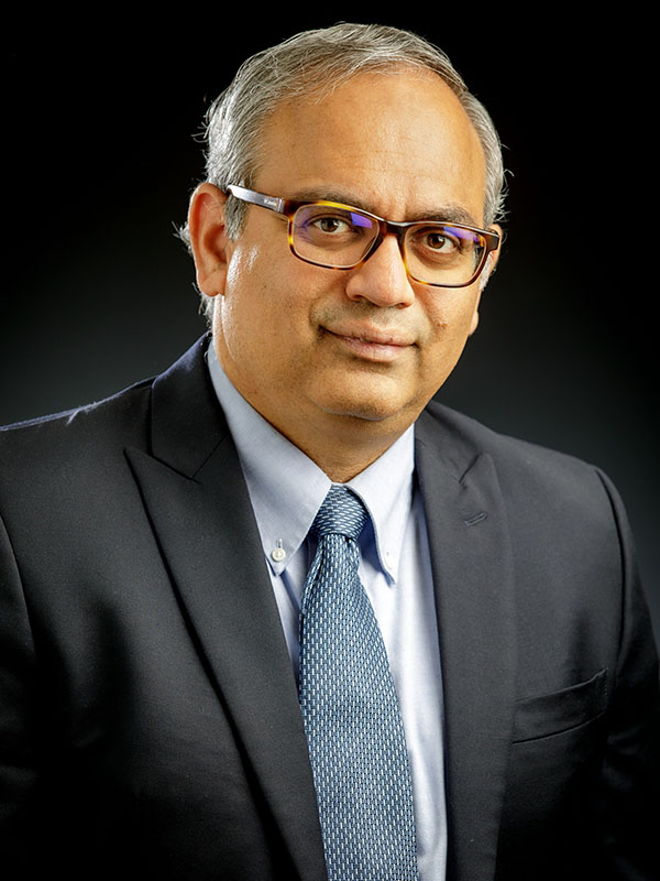 A man poses for a professional headshot.