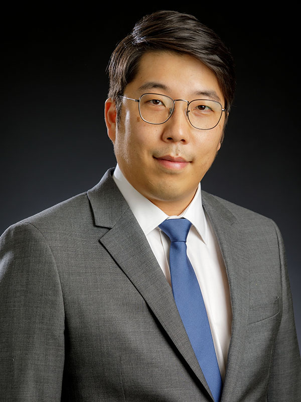 A man poses for a professional headshot.