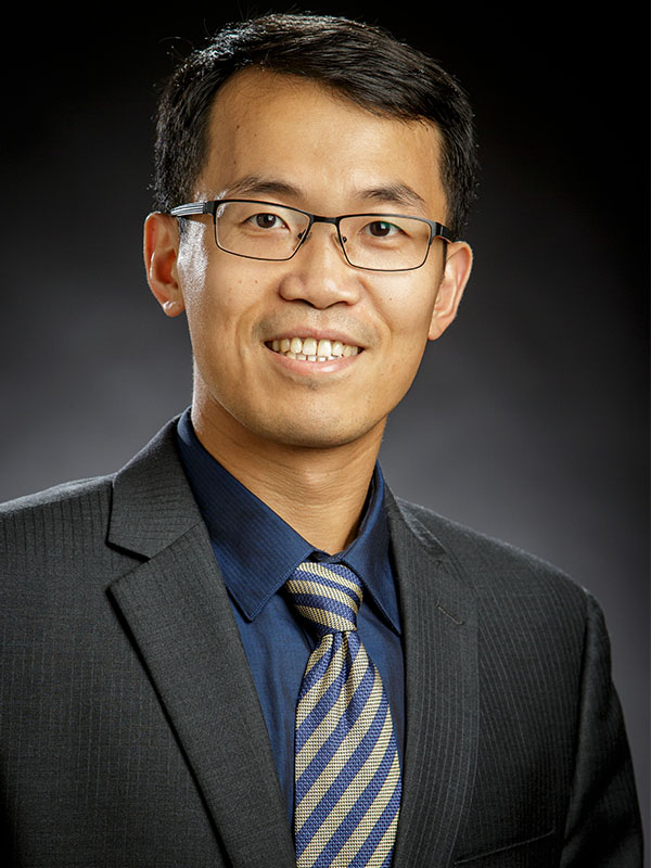 A man poses for a professional headshot.