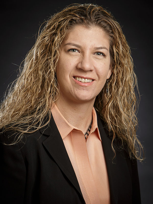 A woman poses for a professional headshot.