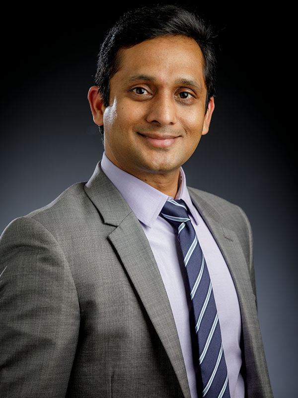 A man poses for a professional headshot.