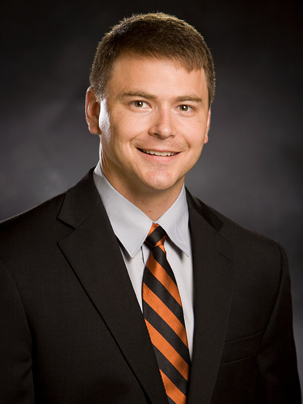 A man poses for a professional headshot.