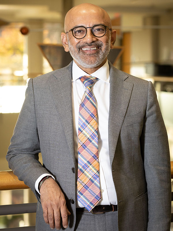 A man poses for a professional headshot.