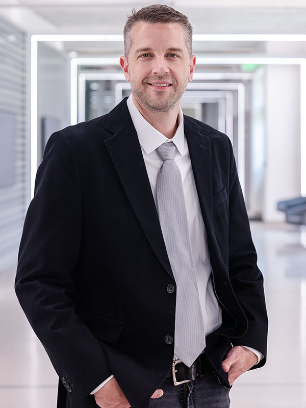 A man poses for a professional headshot.