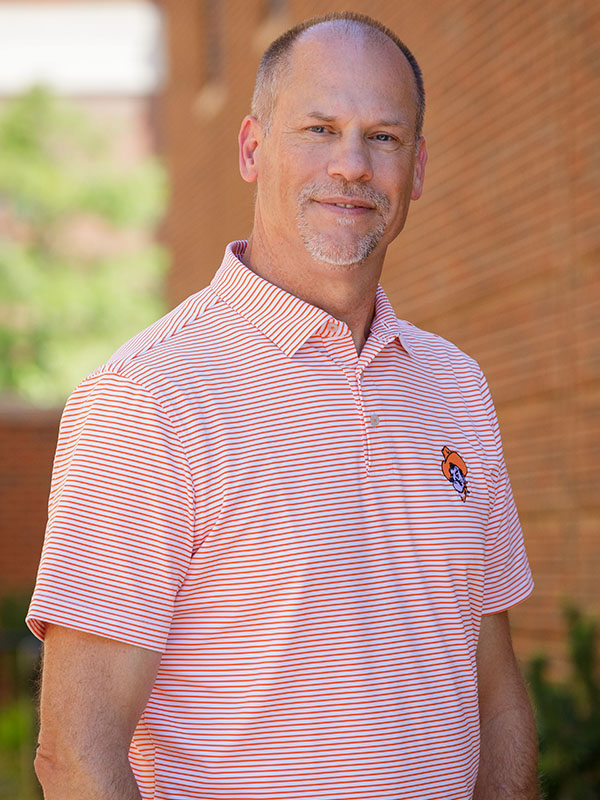A man poses for a professional headshot.