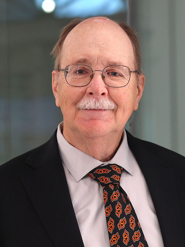A man poses for a professional headshot.