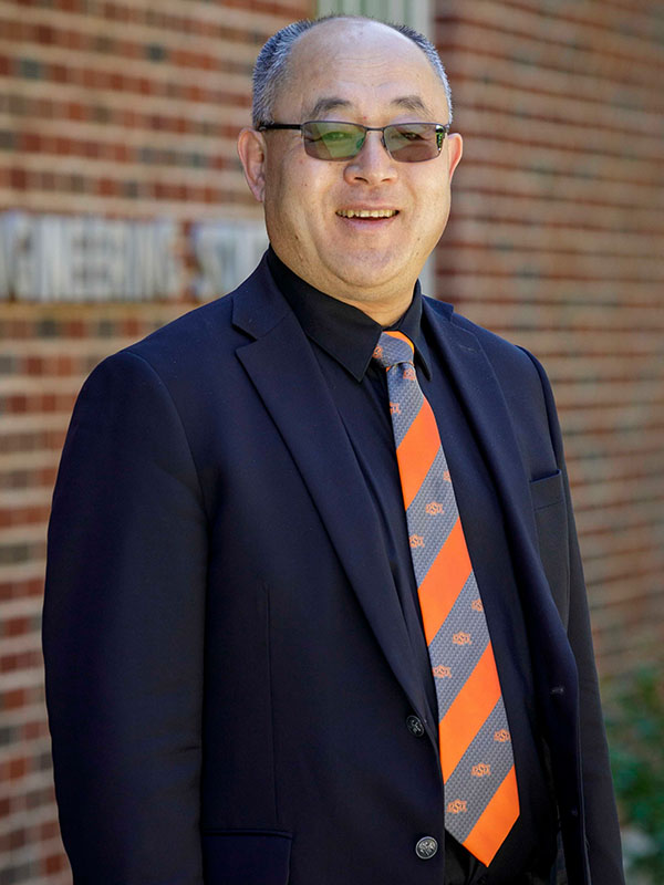 A man poses for a professional headshot.