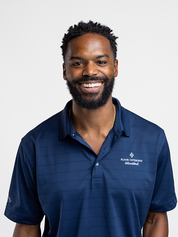 Professional headshot of a Floor Coverings International team member wearing a navy blue polo shirt.
