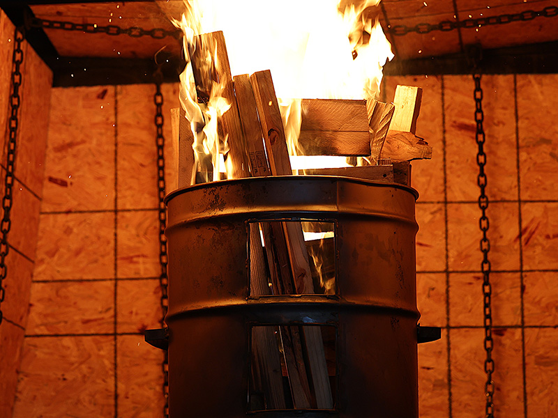 A barrell with fire coming out