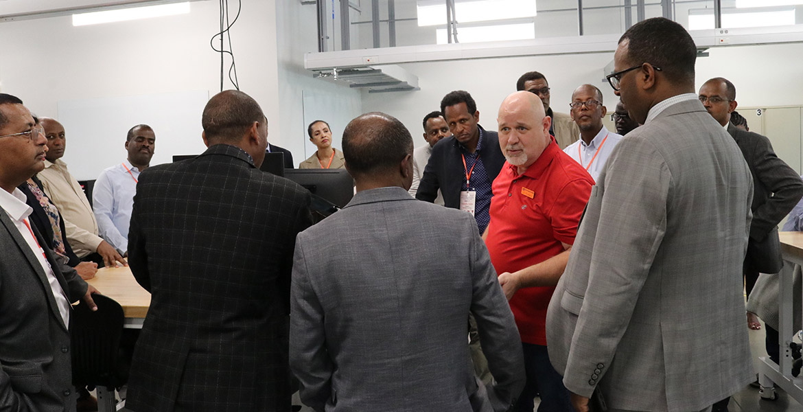 The delegates gather around Dr. Brad Rowland for a tour of the Endeavor Laboratory