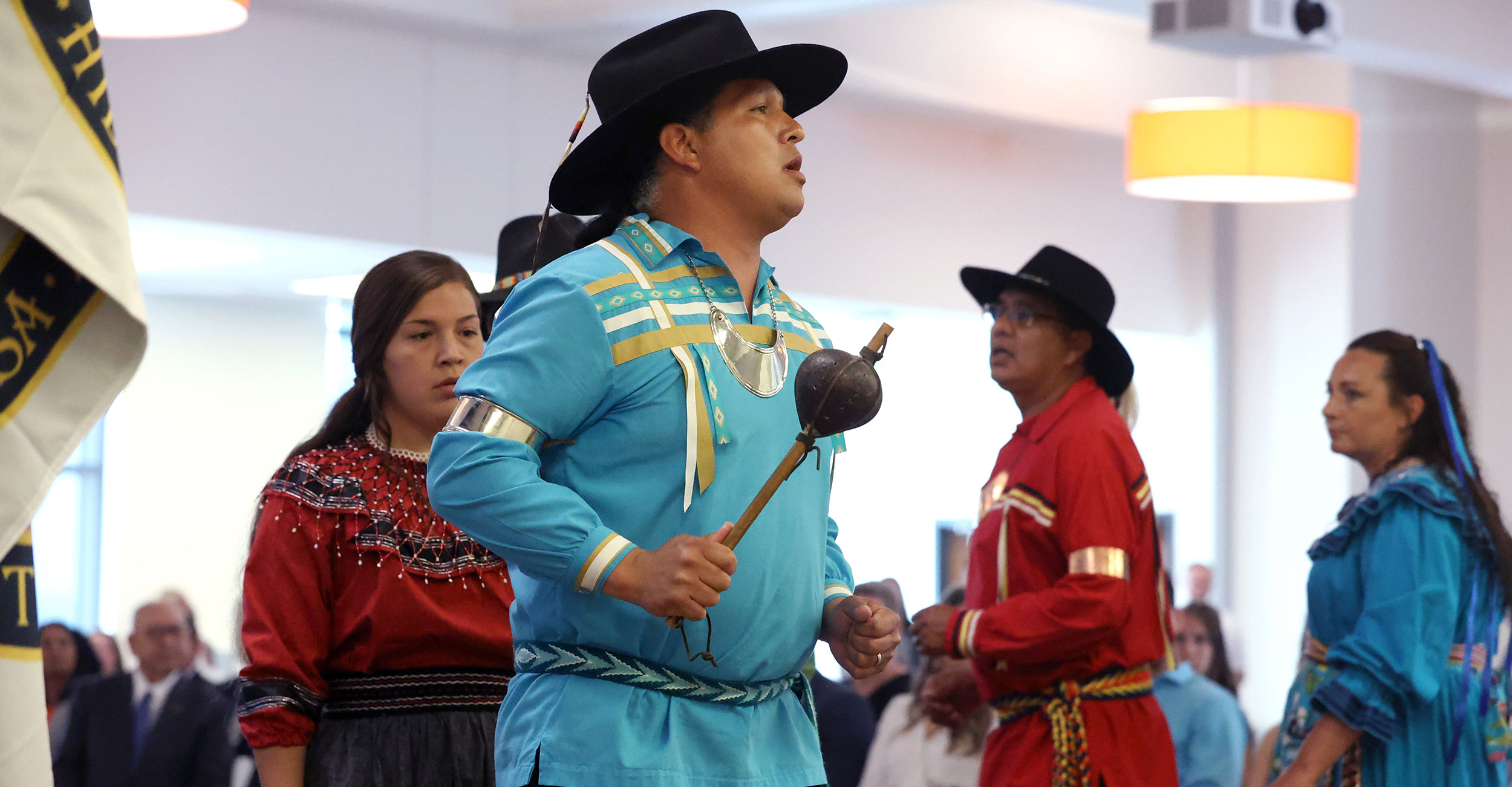 Jason Eyachabbe (foreground) from the Chickasaw Nation Dance Troupe takes part in the American Indian Honoring Ceremony at the OSU Center for Health Sciences.