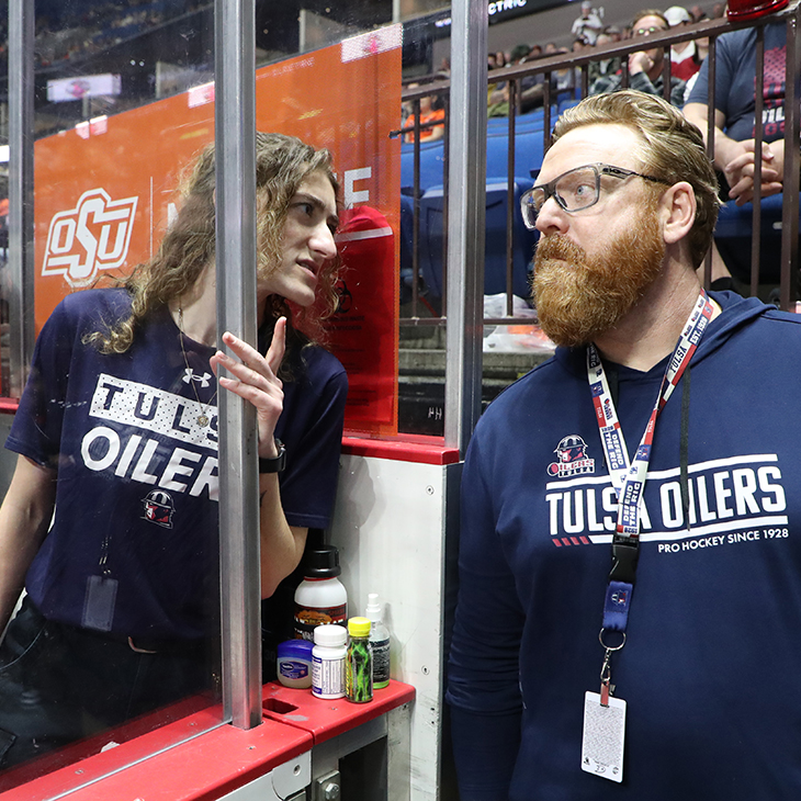 Athletic trainer Sara Latos talks with OSU Sports Medicine team physician James Cornwell before a Tulsa Oilers hockey game.