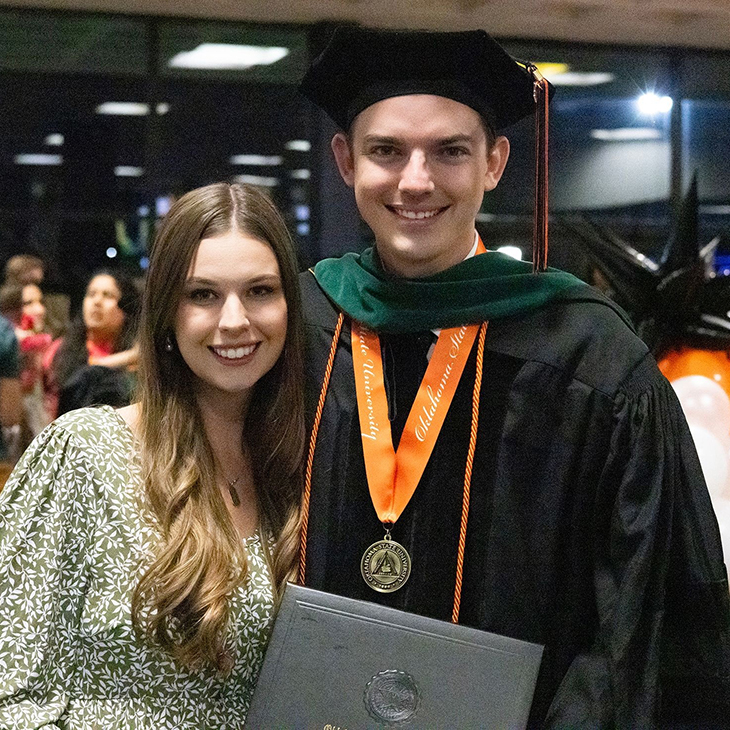 Brandon Garner and his wife, Emily, celebrate his graduation from OSU College of Osteopathic Medicine in May 2024