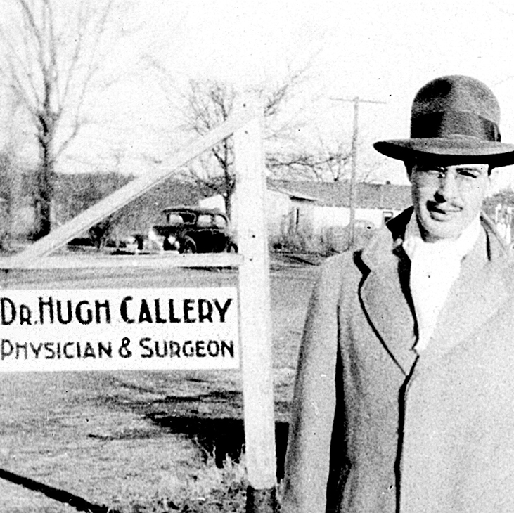 Dr. Hugh Callery stands in front of the sign to his medical practice in Locust Grove in 1941.