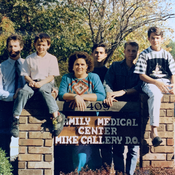 Dr. Mike Callery poses with is family at the sign for his family medicine practice in Sallisaw in 1991.