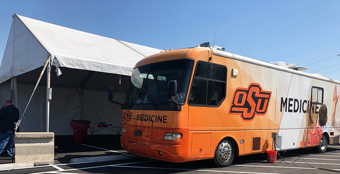 OSU Medicine's mobile medical bus parked in the OSU Center for Health Sciences parking lot.