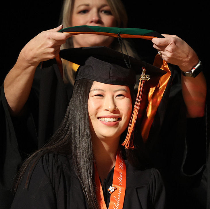 An OSU-CHS Physician Assistant graduate is hooded during the commencement ceremony on Oct. 19, 2023.