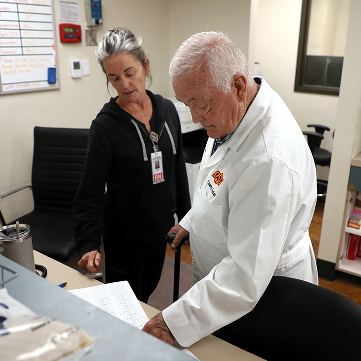 Dr. James Graham looks over paperwork with a nurse at Rural Wellness Fairfax Hospital in Fairfax, Oklahoma.