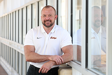 Dr. Jesse Shaw stands in the airbridge on the Oklahoma State University Center for Health Sciences campus.