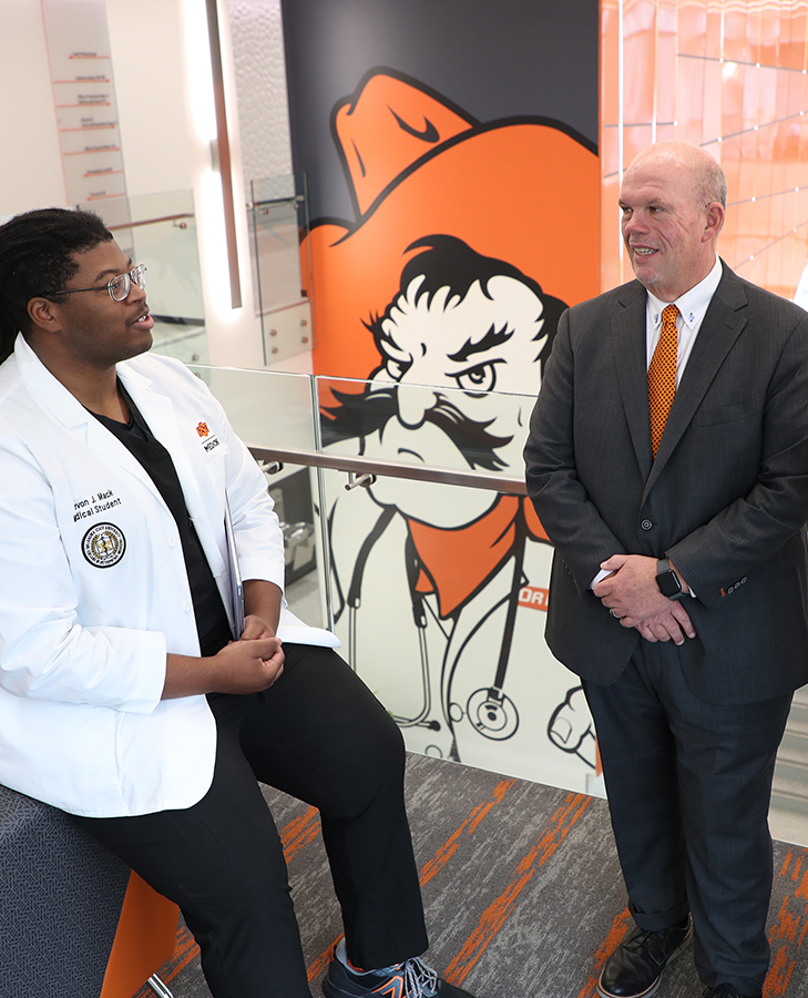 Oklahoma State University Center for Health Sciences President Johnny Stephens talks with an Oklahoma State University College of Osteopathic Medicine student on the O.S.U.C.H.S. campus.