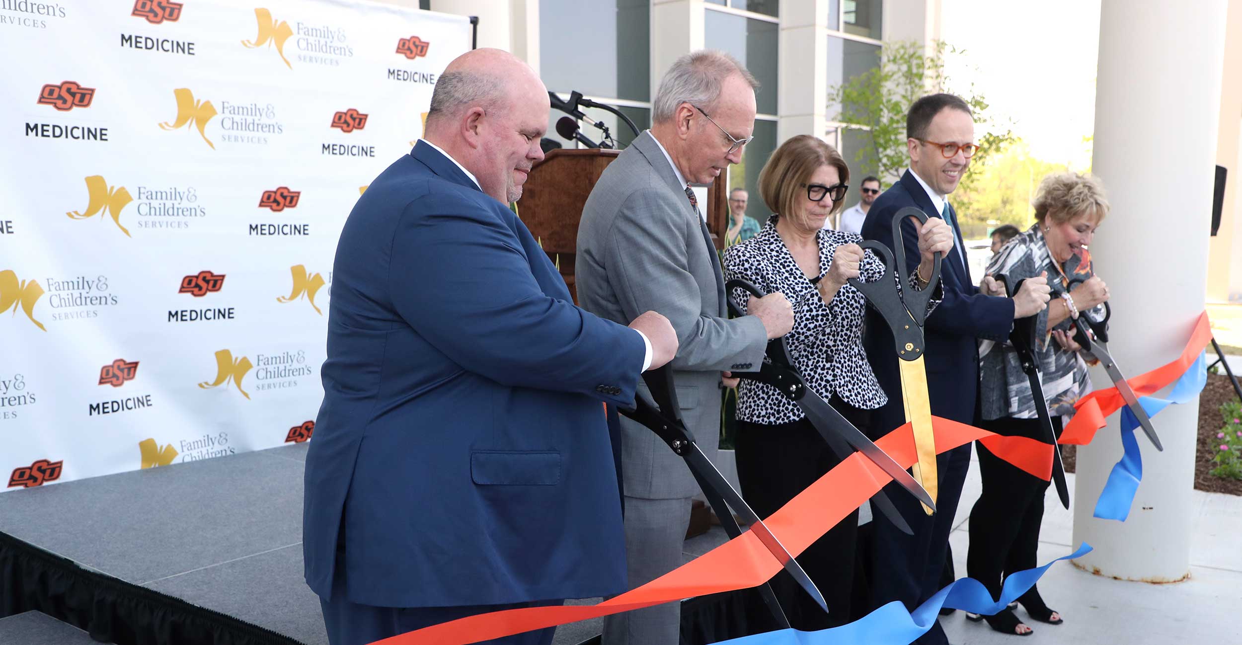 Johnny Stephens (left), President of OSU-CHS, Bill Major, Executive Director of the Anne & Henry Zarrow Foundation, Judy Kishner, Trustee from the Anne & Henry Zarrow Foundation, Tulsa Mayor G.T. Bynum and Gail Lapidus, CEO of Family & Children’s Services, take part in the ribbon-cutting for Legacy Plaza West in Tulsa on Tuesday, April 26, 2022.