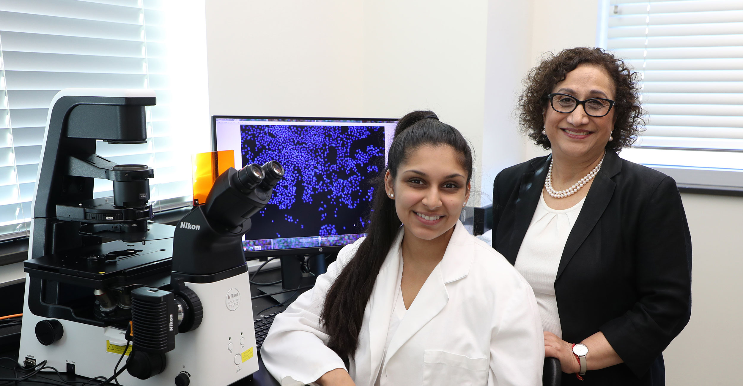 Rashmi Kaul, (right) Ph.D., and professor of immunology stands with her research student Sachi Pathak (left), who is also a medical student at OSU College of Osteopathic Medicine.