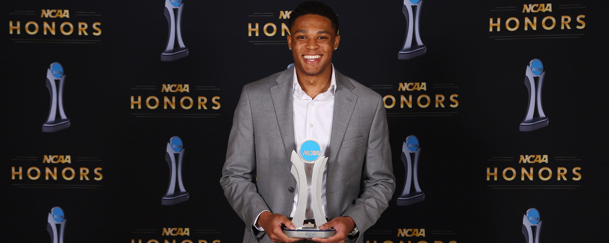 Medical student Micaylon Moore with the Impact Award trophy at the 2026 N.C.A.A. Convention.