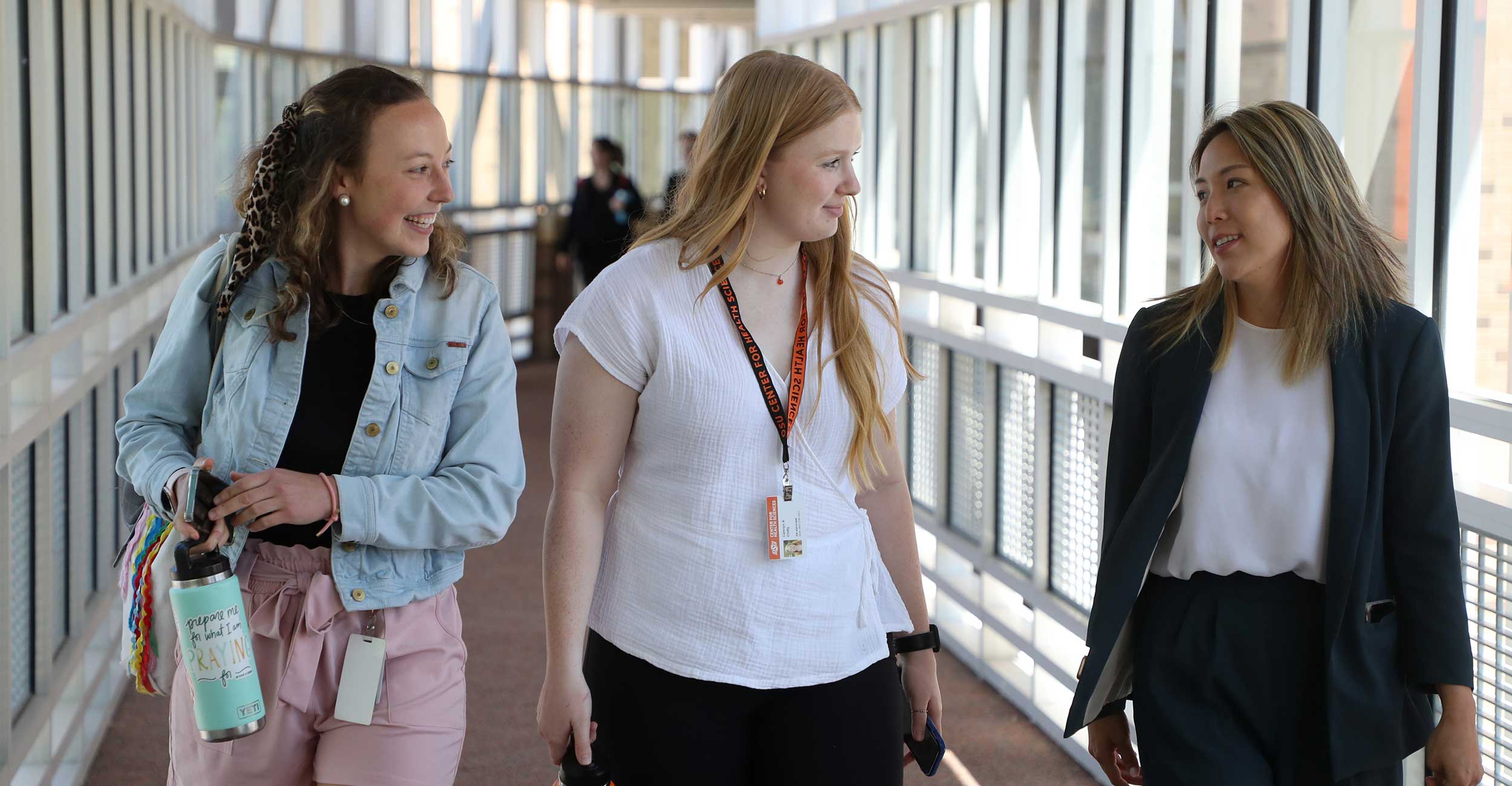 Physicians Assistant students Keely Ratcliff (left), Camryn Chitty and Hana Hu-Lorin (right) walk across campus during orientation at OSU Center for Health Sciences on June 29, 2022.